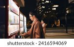 Small photo of Vending machine, man and phone payment at night, automatic digital purchase or choice in city outdoor. Smartphone, shopping dispenser and Japanese business person on mobile technology in urban Tokyo