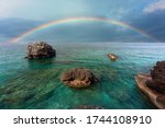 Rainbow appears obove rocks in...