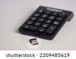 A USB receiver for a wireless numeric keypad, isolated on a white background.