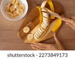 Woman cutting banana slices....