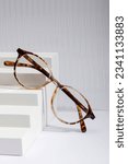 Small photo of Sunglasses and glasses sale concept. Trendy sunglasses background. Trendy Fashion summer accessories. Copy space for text. Summer sale. Optic store discount poster. glasses with rounded frames.