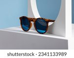 Small photo of Sunglasses and glasses sale concept. Trendy sunglasses background. Trendy Fashion summer accessories. Copy space for text. Summer sale. Optic store discount poster. glasses with rounded frames.