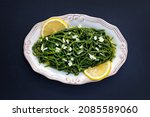 Small photo of Sea beans, glasswort, salicornia salad with onion and lemon on a plate