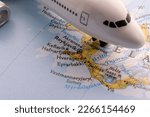 Passenger plane on a map highlighting Reykjavik, Iceland through selective focus, background blur