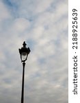 A Pigeon Rests On A Lamppost