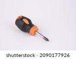 Tiny crosshead screwdriver with a plastic orange handle, isolated over the white background