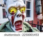 Small photo of Copenhagen, Denmark - Oct 21, 2018: Ghastly painted plastic zombie face displayed on the street in celebration of the Halloween festival. Close-up view.