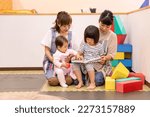 Small photo of A babysitter woman working at a nursery school, daycare center, or children's center