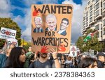 Small photo of London UK - Oct 21 2023: A pro-Palestinian protester holds a placard accusing Biden, Sunak and Netanyahu of war crimes at a demonstration against Israeli attacks on Gaza in central London, UK.