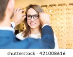 View of a Young attractive  woman testing new glasses with optician
