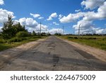 Small photo of Asphalt road and began to deteriorate because the truck overloaded the standard set. Old asphalt road in patches on a sunny summer day. Concept is part of the danger on the road