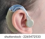 Small photo of Child with hearing aid and hearing problem. Girl suggests hearing aid