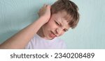 Small photo of Teenage boy suffers from severe ear pain or ear pain. Ear inflammation, otitis or tinnitus