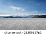 Small photo of A wide-angle ground with a clear sky and mountainous background for vehicles or products placement