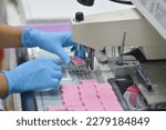 Small photo of A pathologist is preparing a pathological biopsy for laboratory diagnosis of pathology.