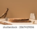 Wood pieces podium with stones and branches decorations. Background for perfume, jewellery and cosmetic products. Front view.
