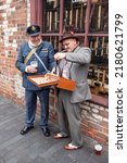 Small photo of Dudley, West Midlands-united kingdom July 13 2019 vertical format RAF airman buying black market goods from a male street seller 1940's war time ration concept