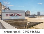 Small photo of seafood sign buy the main beach at margate during a summer heat wave