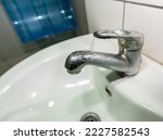 Water tap water with dirty sink close up. chrome faucet wash basin. Hygiene, Cleaning concept.