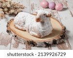 Traditional easter sweet lamb cake with powdered sugar, willow, eggs, wood and sack on wooden background, stock photo 
