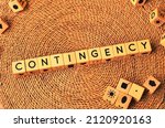 Small photo of CONTINGENCY word text from wooden cube block letters on braided rattan mats background. Contingency is a future event or circumstance which is possible but cannot be predicted with certainty.