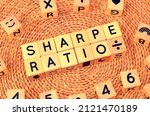 SHARPE RATIO word text from wooden cube block letters. Sharpe ratio measures the performance of investment such as a security or portfolio compared to a risk-free asset, after adjusting for its risk.