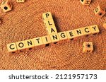 Small photo of CONTINGENCY PLAN word text from wooden cube block letters on braided rattan mats background. Contingency plan is a plan devised for an outcome other than in the usual or expected plan.