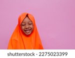 Small photo of portrait of an african muslim young girl smiling and overexcited, small girl