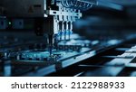 Automatic Pick and Place machine quickly installs Components on Circuit Board. Electronics and Circuit board Manufacturing. Dark Environment