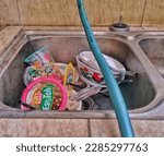 Small photo of April 6, 2023.Sidoarjo-Indonesia.photo, water hose, dirty dishes and cutlery left in the dishwasher. can be detrimental to health.