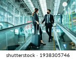 Small photo of Business New normal concept.Traveler businessman and woman wear face mask on escalator at terminal airport,New normal of people to awareness and protection for prevent coronavirus or covid-19 pandemic