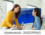 Small photo of Friendly female colleagues having good relationships,Colleagues in office.pleasant conversation at workplace during coffee break, smiling young woman listen talkative coworker,happy,good Colleagues