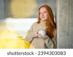 Red haired young woman wear cosy warm favorite sweater at home. Mother drinking warm tea with herbals, while baby is sleeping. Candid moment of relaxation and tranquility. Enjoying real moment.