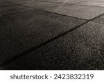 Small photo of The surface texture of the floor on the children's playground in the city park center is made of blackish rubber
