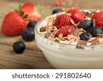 mÃ¼sli with fruit and yogurt on wooden background