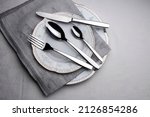 Elegance empty plate, grey napkin, cutlery set