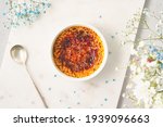 Small photo of Creme brulee. Traditional French vanilla cream dessert. Burned cream, burnt creme or Trinity cream. Spanish crema catalana, rich custard base topped with layer of hardened caramelized sugar. Top view