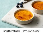 Small photo of Spanish crema catalana. Creme brulee. Traditional French vanilla cream dessert. Burned cream, burnt or Trinity creme. Rich custard base topped with layer of hardened caramelized sugar.