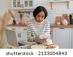 Small photo of African-american woman paying bills on smartphone. Concept of calculating expenses and planning budget. Communal and mortgage payments. Financial checking. Saving money. Paying off debt