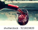 pouring red wine. Wine in a glass. selective focus, motion blur, Red wine in a glass. Sommelier wine into the glass on a blue background old.