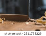 Small photo of Carpenter using a chisel to carve wood - Carpentry craftsmanship and handwork. High quality photo