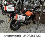 Small photo of Tel Aviv, Israel - 01.04.2023: this vertical image image illustrates paramedics in Israel by depicting an orange motorcycle of the United Hatzalah paramedic organisation parked on a sidewalk.