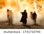 Portrait western cowboys riding horses, roping wild horses in Mexico and America.Smoke background.