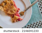 Small photo of Rhubarb pie on white plate with light green, mint crocheted placemat