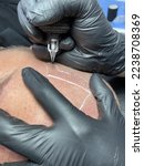 Small photo of Performing hair micropigmentation procedure First session