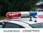 A close up of a swithched rotating beacon of a police car. Cop car rooftop flashing lights outdoors. The top of the police patrol car with flasher and antennas. A patrol car lights. Accident