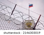 Small photo of The concept of European and US sanctions pressure on the Russian Federation government. flag of the Russian Federation in barbed wire, sanctions and aggression of Russia. Russian prison