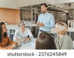 Small photo of Group of successful managers planning project, startup, working together in modern office. Attractive businessman explaining something to his colleagues. Teamwork, seminar, successful business