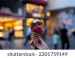 Woman's hand holding cornet ice cream. Ice cream.