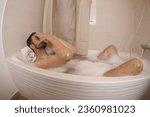 Small photo of Man feeling preoccupied in the bathtub